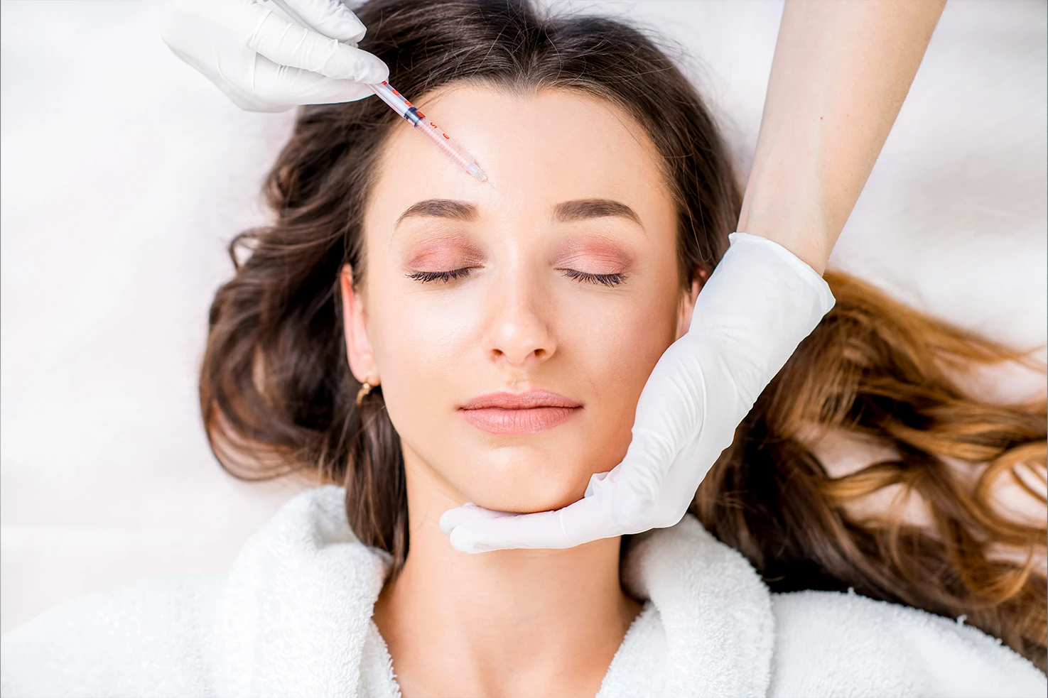 Woman receiving Botox cosmetic injections at top Austin med spa for wrinkle smoothing and facial rejuvenation