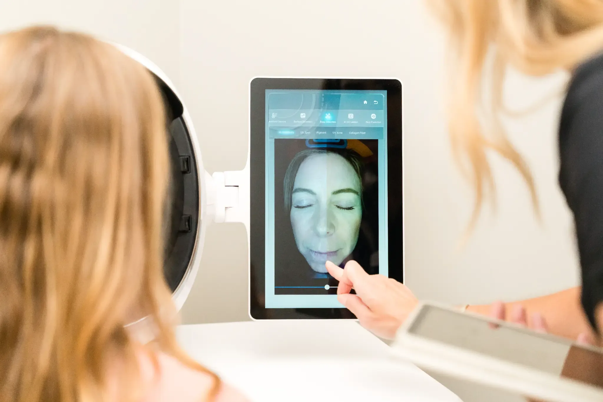 AI 3D Skin Analysis: a provider walking a client through her scan at Banyan and Bamboo, South Lamar Austin